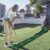 HUAEN GOLF ACCELERATOR PRO – Indoor Golf Putting Mat with Auto-Ball Return & Behind-the-Hole Ball Collector – Putter Alignment Guides at 3, 5 & 7 Feet, Multidistance Practice, Smooth Surface, Practice Enthusiasts